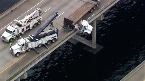 truck hanging over bridge today
